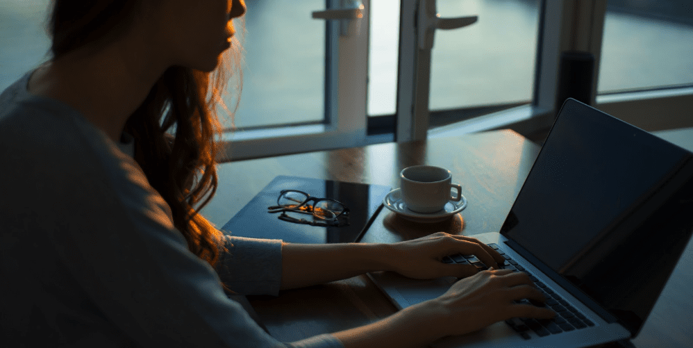 woman studying degree on laptop from home